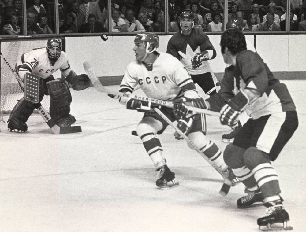PETER BREGG / THE CANADIAN PRESS FILES
Gennadiy Tsygankov, center, of the Soviet hockey team eyes the puck after it was raised off the ice during the first of a four game series between Team Canada and the Soviet team, in Montreal, Sept. 2, 1972.