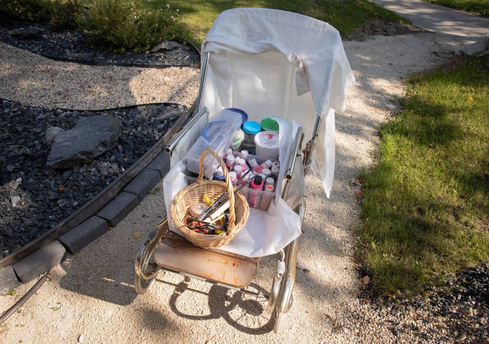 JESSICA LEE / WINNIPEG FREE PRESS
Doyle keeps her weather-resistant acrylic paint and other supplies in an old pram.
