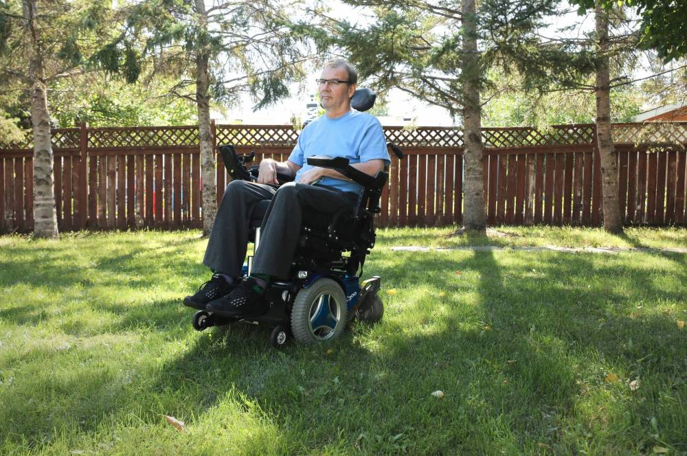 RUTH BONNEVILLE / WINNIPEG FREE PRESS
Local home care / quadriplegia Photo of Patrick Dram with quadriplegia in his wheelchair outside. He says home care isnմ always there for their four times a day visits. This weekend he was left for most of the day in bed because a staff member could not come into work. Story: Patrick Dram slipped and fell going inside his house a year ago and has been left with quadriplegia. He was released from the hospital recently after six months and then has had to live in his parentsՠhouse who are 93 and 83. Sept 6th, 2022