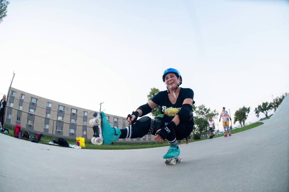 Melanie Nighttraveller does a Shoot the Duck move. (Mike Sudoma / Winnipeg Free Press)