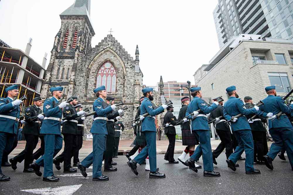 A millitary parade in honor of the late Queen Elizabeth makes its way through the downtown core of Ottawa, Monday, Sept. 19, 2022. THE CANADIAN PRESS/Spencer Colby