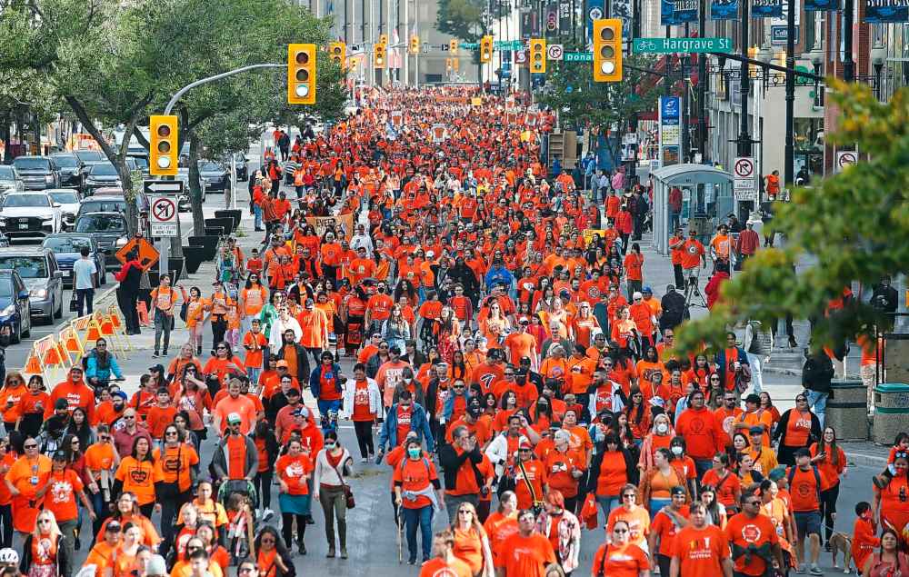 Hundreds of people march through the streets in Winnipeg on Friday. (John Woods / The Canadian Press)