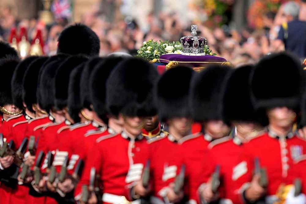 The Imperial State Crown rests on the coffin of Queen Elizabeth II during the procession from Buckingham Palace to Westminster Hall in London, Wednesday, Sept. 14, 2022. The Queen will lie in state in Westminster Hall for four full days before her funeral on Monday Sept. 19. (AP Photo/Frank Augstein, Pool)