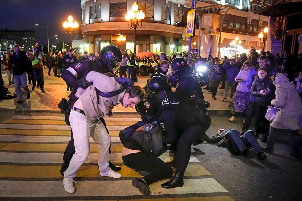 Riot police detain demonstrators during a protest against mobilization in Moscow, Russia, Wednesday, Sept. 21, 2022. Russian President Vladimir Putin has ordered a partial mobilization of reservists in Russia, effective immediately. (AP Photo/Alexander Zemlianichenko)