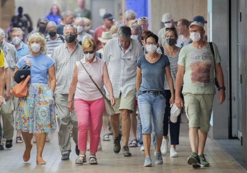 People wear face masks as they walk through a subway station in Montreal, Sunday, July 17, 2022, as the COVID-19 pandemic continues in the province. The number of hospitalizations linked to COVID-19 in Quebec has risen above 2,000 for the first time since mid-August. THE CANADIAN PRESS/Graham Hughes