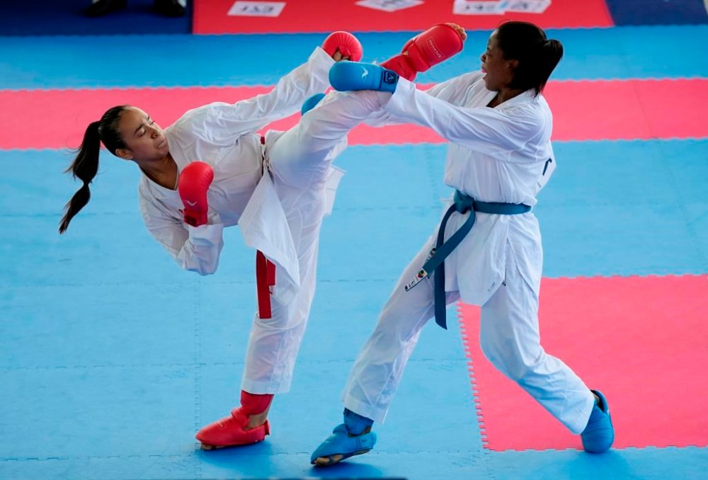 Luis Fernanda, left, of Guatemala, and Wendy Mosquera, of Colombia, compete in the women's kumite 68kg karate elimination round at the Bolivarian Games in Valledupar, Colombia, Sunday, June 26, 2022. Plans for the Quebec Cup were postponed Thursday due to