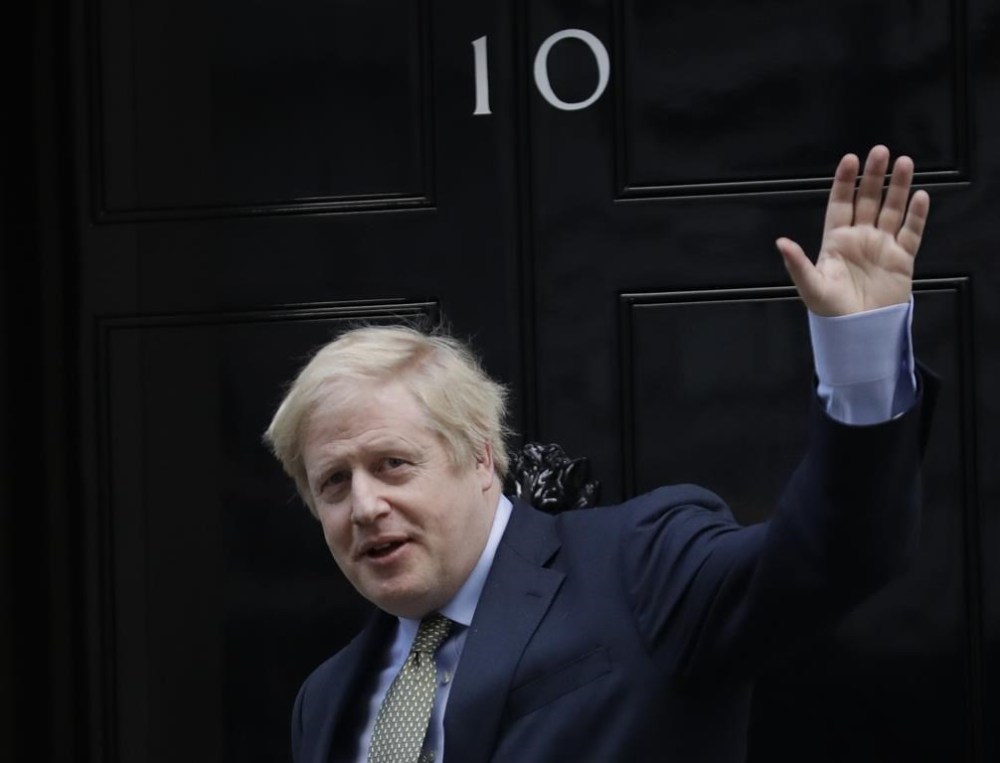 FILE - Britain's Prime Minister Boris Johnson returns to 10 Downing Street after meeting with Queen Elizabeth II at Buckingham Palace, London, on Friday, Dec. 13, 2019. Under Britain's parliamentary system, the public never actually votes for its prime minister. Instead, voters tick the box for a representative from their local area, who then becomes one of Britain’s 650 Members of Parliament. The party that wins a majority forms a government and puts their leader into the prime minister's seat. (AP Photo/Matt Dunham, File)