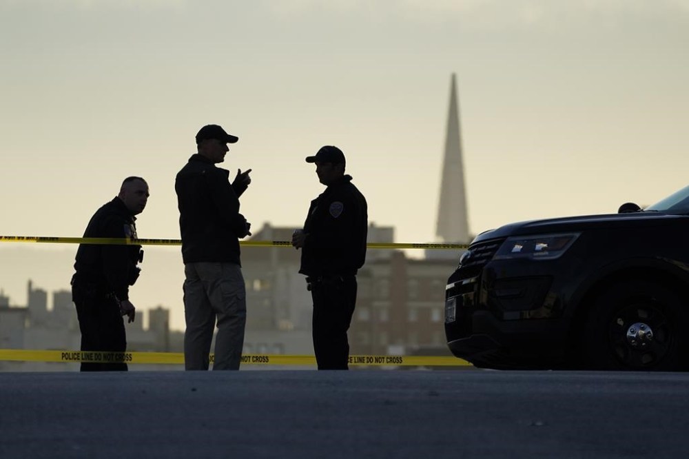 FILE - Police stand at the top of the closed street outside the home of House Speaker Nancy Pelosi and her husband Paul Pelosi in San Francisco, Friday, Oct. 28, 2022. Within hours of the attack on Paul Pelosi, conspiracy theories deflecting blame for the assault on the husband of U.S. Speaker Nancy Pelosi were already swirling online. (AP Photo/Eric Risberg, File)