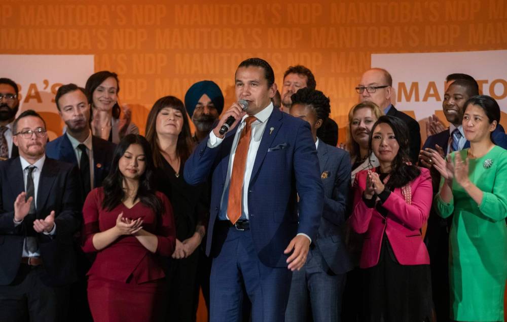 Manitoba NDP Leader Wab Kinew (centre) leaned heavily on the contrast between his party and the governing Progressive Conservatives during his speech to delegates. (Jessica Lee / Winnipeg Free Press)
