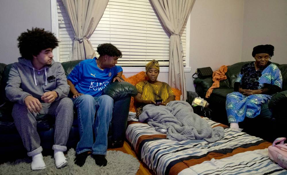JESSICA LEE / WINNIPEG FREE PRESS
Family and friends Bunguke gathered in the family home on Friday, days after his death. From left: Classmates Mohamed-Omar Zellama and Raphael Vrignon, with mom of Bunguke, Sylivie Musobwa.