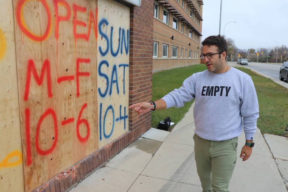 TYLER SEARLE / WINNIPEG FREE PRESS
Jonathan Torchia, owner of City Park Runners, points out the damage to his Portage Avenue storefront caused by a car that jumped the curb, smashed the front windows and rolled over in a neighbouring vacant lot Friday night.