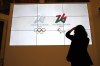 FILE - The logo of 2026 Milan-Cortina Olympics and Paralympics, right, are unveiled to the journalists at a press conference in Rome, March 30, 2021. Another expensive venue for the 2026 Milan-Cortina Winter Olympics has been approved, with a 50 million euro ($50 million) project slated to place a roof over the outdoor speedkating oval in Baselga di Pine. The Milan-Cortina organizing committee said Tuesday, Nov. 8, 2022 that it couldn’t comment on 