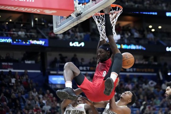 Portland Trail Blazers forward Jerami Grant (9) slam dunks over New Orleans Pelicans guard Trey Murphy III, right, and forward Herbert Jones, left, in the second half of an NBA basketball game in New Orleans, Thursday, Nov. 10. The Trail Blazers won 106-95. (Gerald Herbert / The Associated Press)