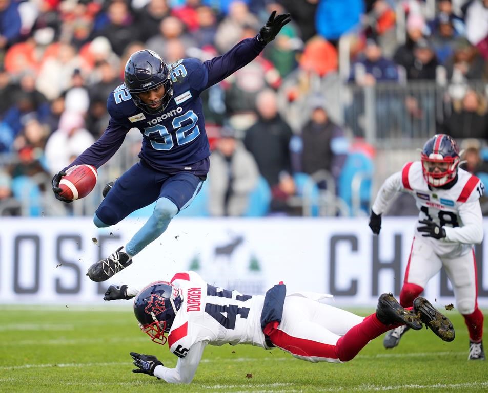 Toronto Argonauts running back Javon Leake (32) evades a tackle from Montreal Alouettes defensive back Kenneth Durden (45) on a kick return during first half CFL Eastern Final football action in Toronto on Sunday, November 13, 2022. THE CANADIAN PRESS/Mark Blinch