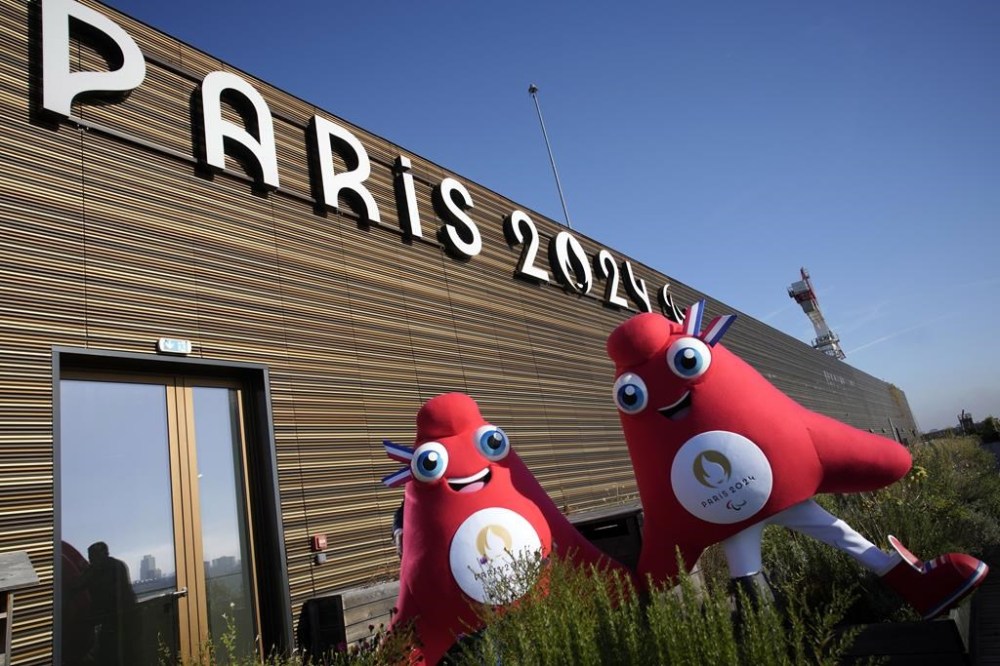 Mascots of the 2024 Paris Olympic Games, left, and Paralympics Games, a Phrygian cap, pose during a preview in Saint Denis, outside Paris, Thursday, Nov. 10, 2022. The soft bright red cap, also known as a liberty cap, is an updated version of a conical hat worn in antiquity in places such as Persia, the Balkans, Thrace, Dacia and Phrygia, where the name originates, in modern day Turkey. It later became a symbol of the pursuit of liberty in the French Revolution and is still worn by the figure of Marianne, the national personification of France since that time. (AP Photo/Christophe Ena)