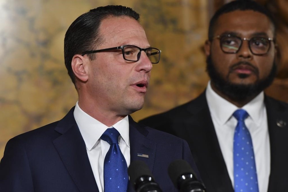 Democratic Gov.-elect Josh Shapiro of Pennsylvania speaks during his first Capitol news conference, Nov. 16, 2022, in Harrisburg, Pa. Looking on is Shapiro's running mate in the fall election, Lt. Gov.-elect Austin Davis. (AP Photo/Marc Levy)