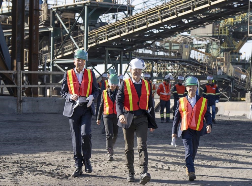 Prime Minister Justin Trudeau arrives with Rio Tinto chief executive Jakob Stausholm, left, and Industry Minister Francois-Philippe Champagne, right, for a tour of a new pilot project for a blue smelting facility at the Rio Tinto plant, on Tuesday, Oct. 11, 2022 in Sorel, Que. THE CANADIAN PRESS/Ryan Remiorz