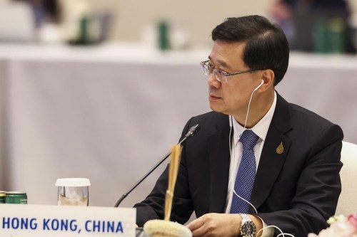 FILE - Hong Kong Chief Executive John Lee attends the APEC Leaders' Informal Dialogue with Guests during the Asia-Pacific Economic Cooperation (APEC) Summit in Bangkok, Thailand on Nov. 18, 2022. The Hong Kong government said Monday, Nov. 21, 2022 that leader John Lee tested positive for COVID-19 after returning from the Asia-Pacific Economic Cooperation meetings in Thailand. (Athit Perawongmetha/Pool Photo via AP, File)