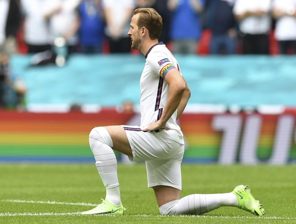 FILE - England's Harry Kane wears a rainbow armband as he takes the knee prior to the Euro 2020 soccer championship round of 16 match between England and Germany at Wembley Stadium in England. The captains of seven European nations will not wear anti-discrimination armbands in World Cup games after threats from FIFA to show yellow cards to the players. The seven soccer federations say