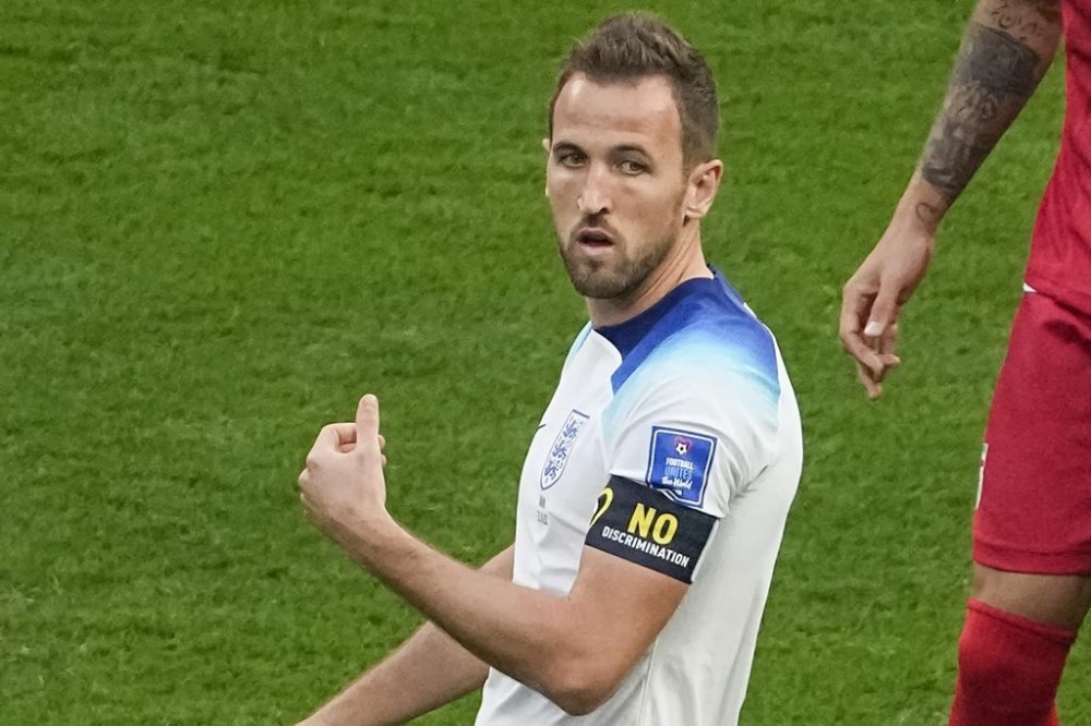 England's Harry Kane gestures wearing a black armband with a sign