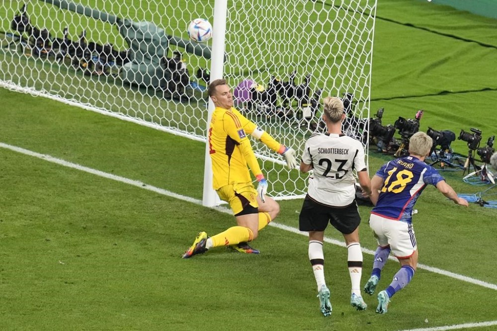 Japan's Takuma Asano, right, scores is side second goal during the World Cup group E soccer match between Germany and Japan, at the Khalifa International Stadium in Doha, Qatar, Wednesday, Nov. 23, 2022. (AP Photo/Ricardo Mazalan)