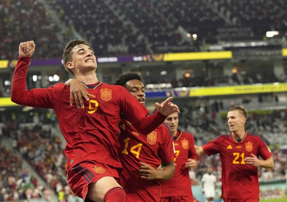 Spain's Gavi, left, celebrates with teammates after scoring his side's fifth goal during the World Cup group E soccer match between Spain and Costa Rica, at the Al Thumama Stadium in Doha, Qatar, Wednesday, Nov. 23, 2022. (AP Photo/Pavel Golovkin)