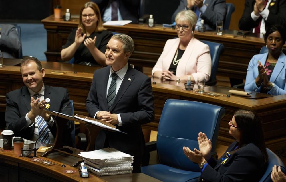 Manitoba Finance Minister Cameron Friesen says the Progressive Conservative government will cut in half the annual water rental rates that Manitoba Hydro pays the province. Friesen delivers the 2022 budget in Winnipeg on April 12, 2022 at the Manitoba Legislative Building. THE CANADIAN PRESS/David Lipnowski