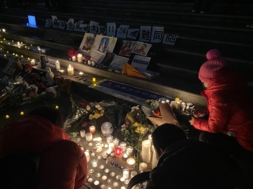 People light candles in front of the Vancouver Art Gallery on Sunday, Nov. 27, 2022, at a rally in sympathy with protests that are sweeping across China. The protest also paid tribute to victims of an apartment fire in northwest China that critics blame on the government's hardline COVID lockdown policies. THE CANADIAN PRESS/Nono Shen