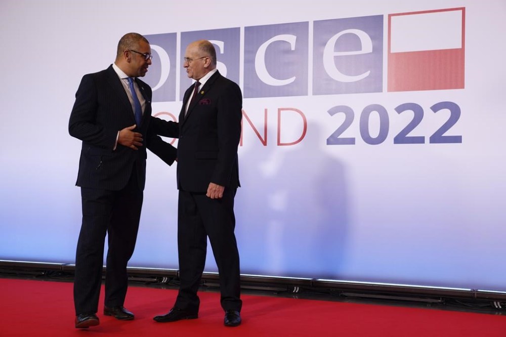 Polish Minister of Foreign Affairs Zbigniew Rau, right, welcomes UK Foreign Secretary James Cleverly, left, during a high-level meeting of the Organization for Security and Cooperation in Europe in Lodz, Poland, Thursday, Dec. 1, 2022. The OSCE is Europe's largest security organization, one founded to maintain peace and stability on the continent. Russia's war against Ukraine is among the greatest challenges the body has faced in its nearly half century of existence. (AP Photo/Michal Dyjuk)