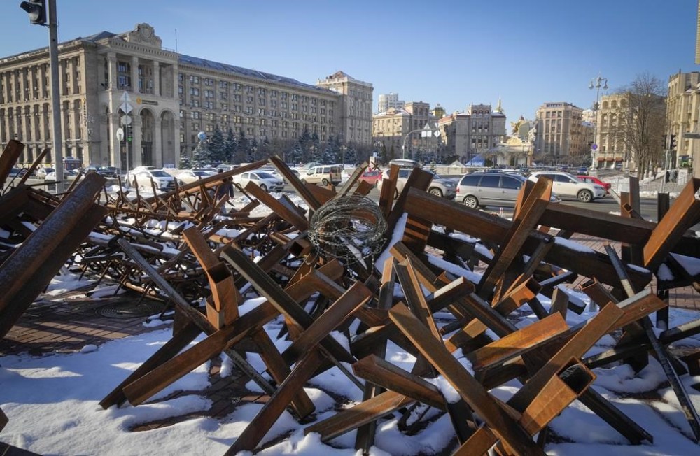 Cars ride past anti-tanks hedgehogs which were installed to protect the city from the Russian troops, in the main square in Kyiv, Ukraine, Thursday, Dec. 1, 2022. (AP Photo/Efrem Lukatsky)