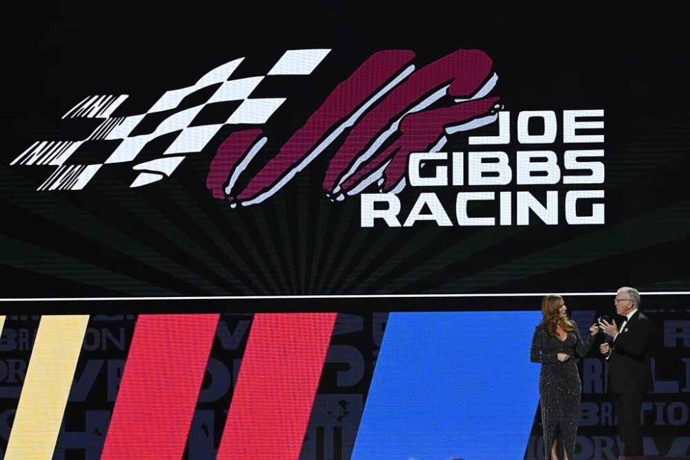Joe Gibbs, right, speaks during the NASCAR Awards on Thursday, Dec. 1, 2022, in Nashville, Tenn. (AP Photo/Mark Zaleski)
