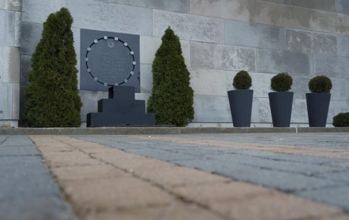 The commemorative plaque is seen on the outside wall at the Polytechnique in Montreal, on Friday, Dec. 4, 2020. THE CANADIAN PRESS/Paul Chiasson