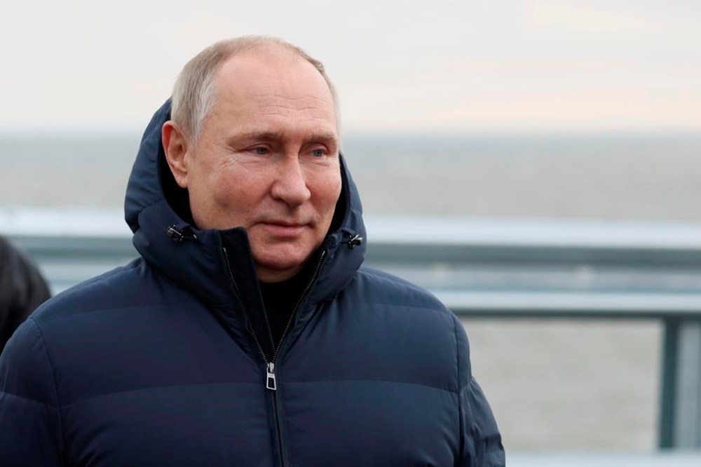 Russian President Vladimir Putin visits the Crimean Bridge connecting Russian mainland and Crimean peninsula over the Kerch Strait, which was damaged by a truck bomb attack in October, after restoration works, not far from Kerch, Crimea, Monday, Dec. 5, 2022. (Mikhail Metzel, Sputnik, Kremlin Pool Photo via AP)