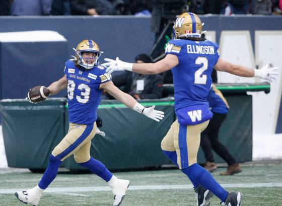 Winnipeg Blue Bombers’ Dalton Schoen (83) and Greg Ellingson (2) celebrate Schoen’s touchdown against the BC Lions during the first half. (John Woods / The Canadian Press)