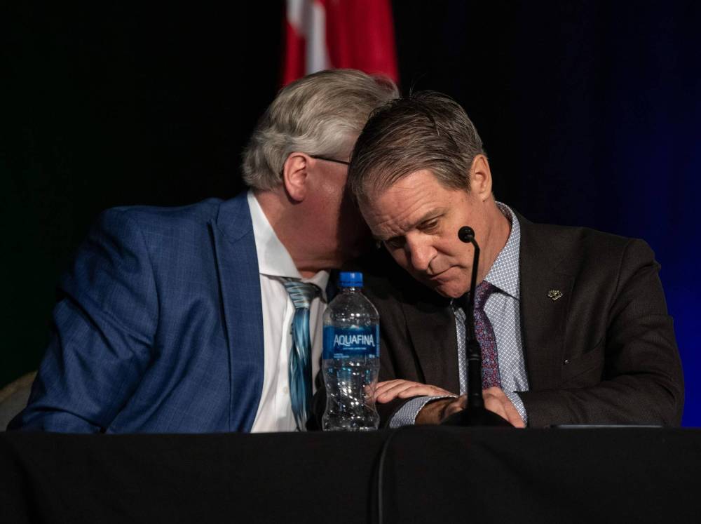 Scott Johnston (left) and Cameron Friesen hold a discussion during the Association of Manitoba Municipalities’ fall convention. (Jessica Lee / Winnipeg Free Press)