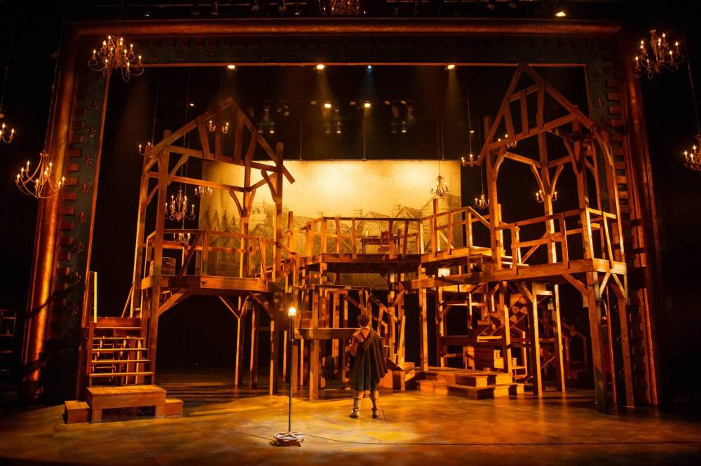 That action ranges all over Brian Perchaluk’s austere but effective set, a series of staircases, platforms and decks of raw wood, with chandeliers that lower when a formal touch is required. (Dylan Hewlett photo)