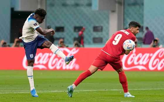 Bukayo Saka (left) scores the second goal for England during the World Cup group B soccer match between England and Iran at the Khalifa International Stadium in Doha, Qatar, Monday. (Frank Augstein / The Associated Press)