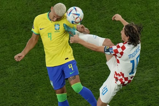 Croatia's Luka Modric, right, fights for the ball with Brazil's Richarlison during the World Cup quarterfinal soccer match between Croatia and Brazil Friday. (Alessandra Tarantino / AP Photo)