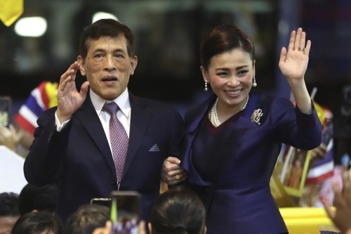 FILE - Thai King Maha Vajiralongkorn and Queen Suthida wave to supporters after presiding over the opening of a new mass transit station in Bangkok, Thailand on Nov. 14, 2020. Thailand's king and queen have tested positive for COVID-19, and so far have only mild symptoms, the royal palace said Saturday, Dec. 17, 2022. (AP Photo/Rapeephat Sitichailapa, File)