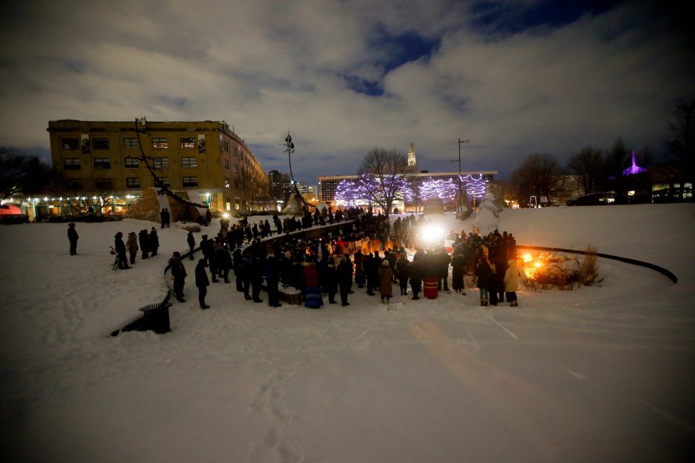 JOHN WOODS / WINNIPEG FREE PRESS
People gather at the Oodena Circle at The Forks for a vigil to name and remember MMIWG Sunday in Winnipeg.