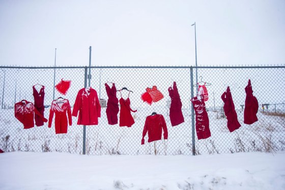 Red dresses hang outside of the Brady Road Landfill in Winnipeg. (Mikaela MacKenzie / Winnipeg Free Press)