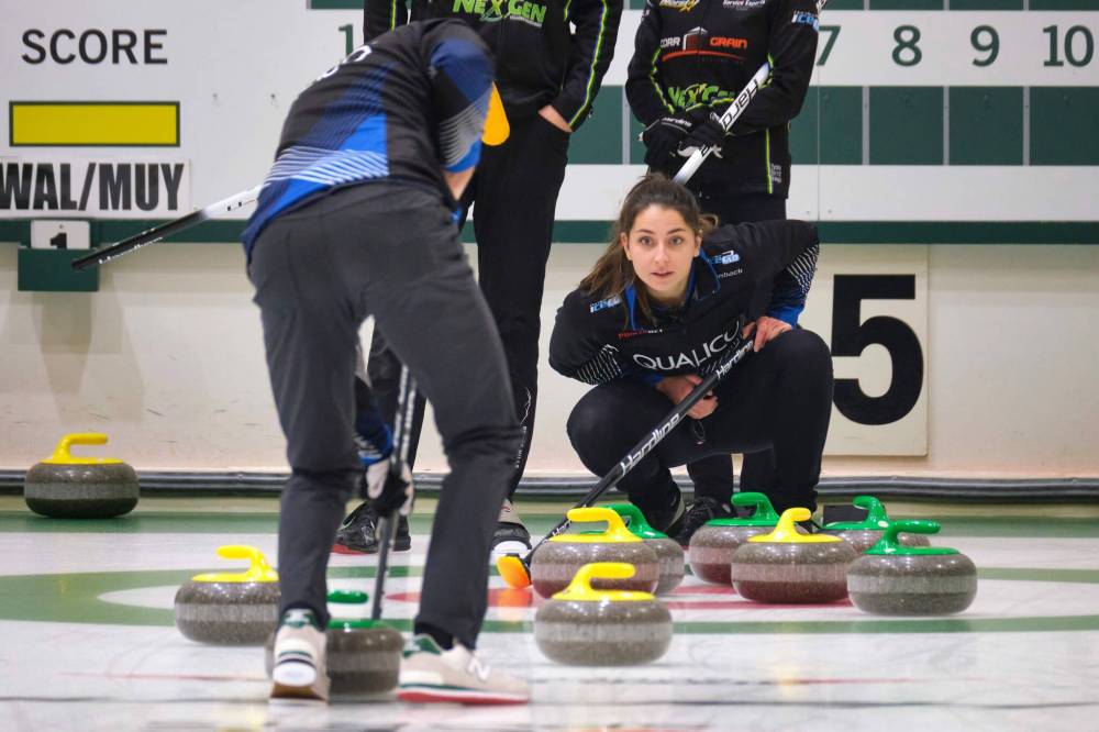 Shannon Birchard (right) and John Morris (sweeping) play against Laura Walker and Kirk Muyres on Friday. (Mike Deal / Winnipeg Free Press)