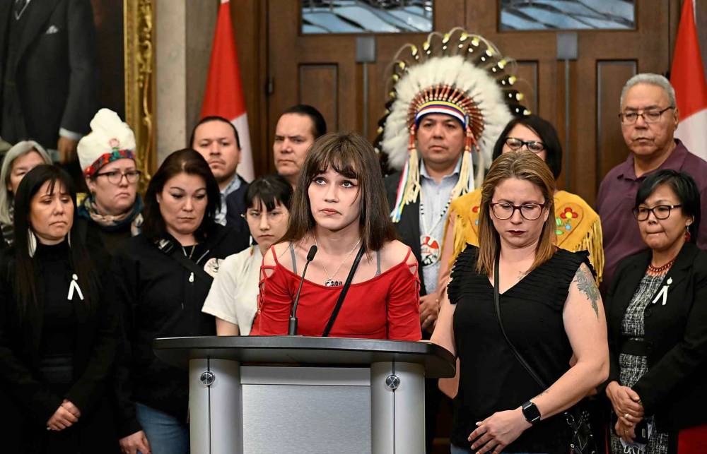 Cambria Harris, daughter of Morgan Harris, speaks during a news conference in the foyer of the House of Commons on, on Dec. 6. (Justin Tang / The Canadian Press files)