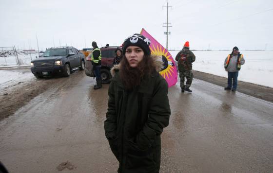 Cambria Harris, daughter of Morgan Harris, stands at the entrance to the Brady Road landfill Sunday. (John Woods / Winnipeg Free Press)