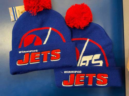 Winnipeg Jets tuques that appear to be legitimate, including the NHL sticker and tags with spelling errors found for sale at both Lids and Jersey City stores at Polo Park Shopping Centre. (Malak Abas / Winnipeg Free Press)