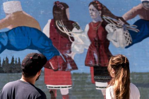 SUPPLIED
                                Diaspora director Deco Dawson and actress Yulia Guzhva check out a mural in the North End during shooting.