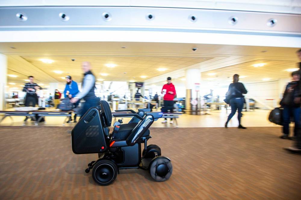 The new self-driving wheelchairs, developed by Winnipeg mobility equipment company Scootaround and Japanese firm WHILL Inc., are the first of their kind to be used in a North America airport. (Mikaela MacKenzie / Winnipeg Free Press)