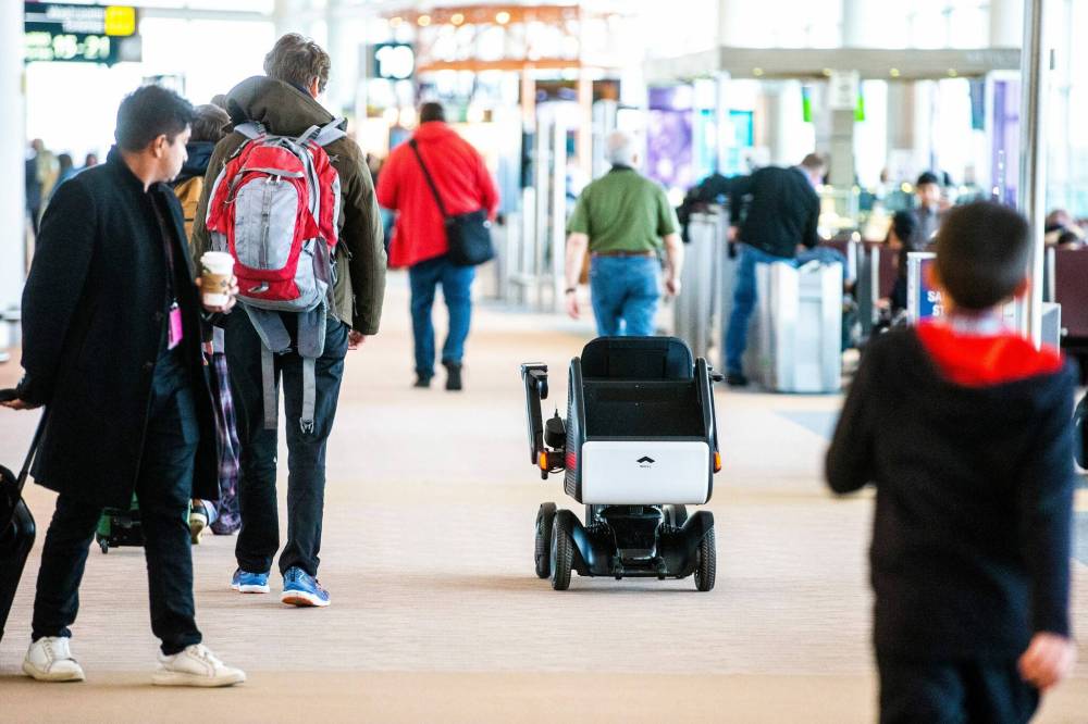 After the user selects their destination on a touch screen, the autonomous power chair transports the passenger safely to the desired gate. (Mikaela MacKenzie / Winnipeg Free Press)