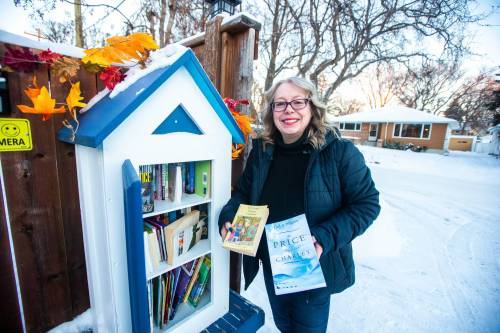 MIKAELA MACKENZIE / WINNIPEG FREE PRESS
Lisa Goss says her little free library on Rossmere Crescent in the Fraser’s Grove Park area helps strengthen community relations and literacy. ‘It’s connection,’ she says.