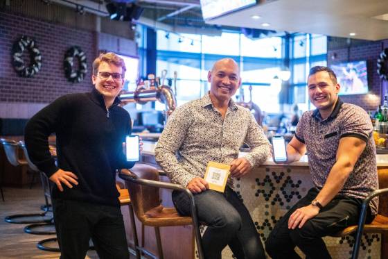 FasTab co-founder Carson Keck (left), Confusion Corner Drinks & Food owner Kevin Byrne, and FasTab co-founder Zechariah Noiseux at Confusion Corner, one of the first restaurants to use FasTab, a program where customers can pay for their bills any time by scanning a QR code. (Mikaela MacKenzie / Winnipeg Free Press)